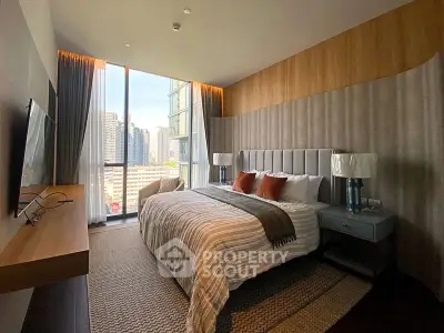 Luxurious bedroom with city view, modern decor, and ample natural light.
