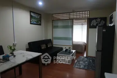 Cozy living room with modern decor and adjacent bedroom view