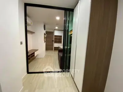 Modern apartment interior with sliding glass doors and wooden flooring