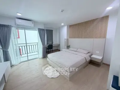 Spacious modern bedroom with balcony access and stylish decor