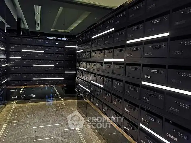 Luxurious modern building entrance with sleek black mailboxes and marble flooring.