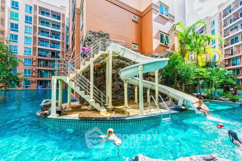 Luxurious residential pool area with water slide and lush landscaping