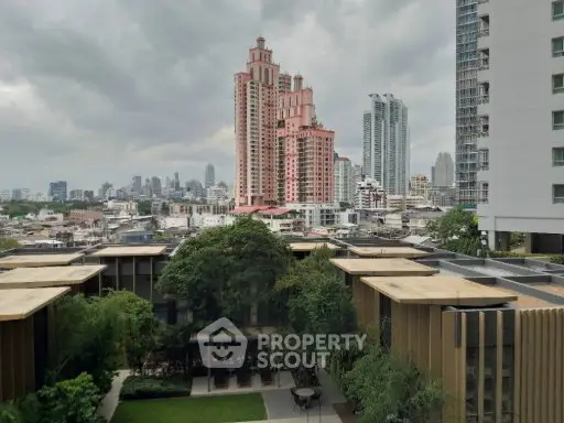 Stunning cityscape view from a modern apartment with lush greenery and iconic skyline.