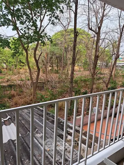 Charming balcony view overlooking lush greenery and serene surroundings.