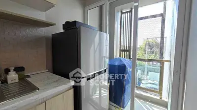 Modern kitchen with balcony view and sleek appliances