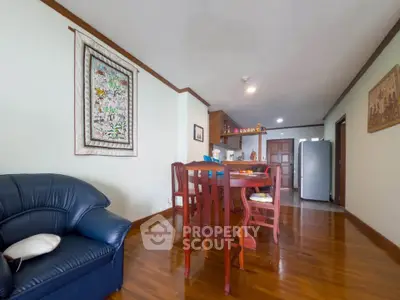 Spacious living room with wooden floors and elegant dining area