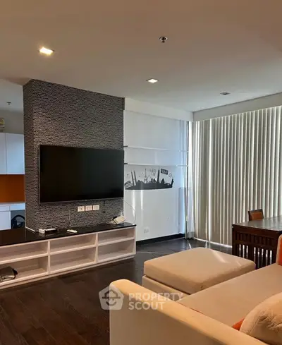 Modern living room with sleek TV setup and cozy seating area