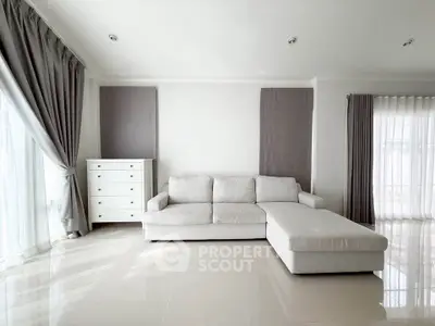 Spacious modern living room with elegant white sofa and natural light