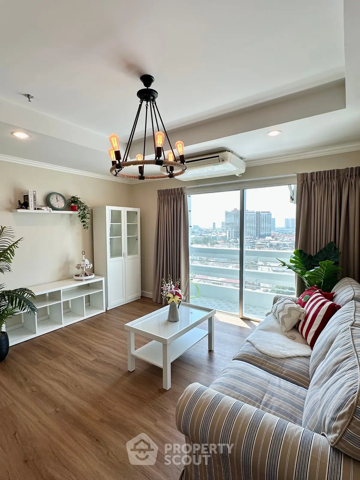 Spacious living room with elegant decor and stunning city view