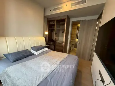 Modern bedroom with stylish decor and ensuite bathroom in luxury apartment