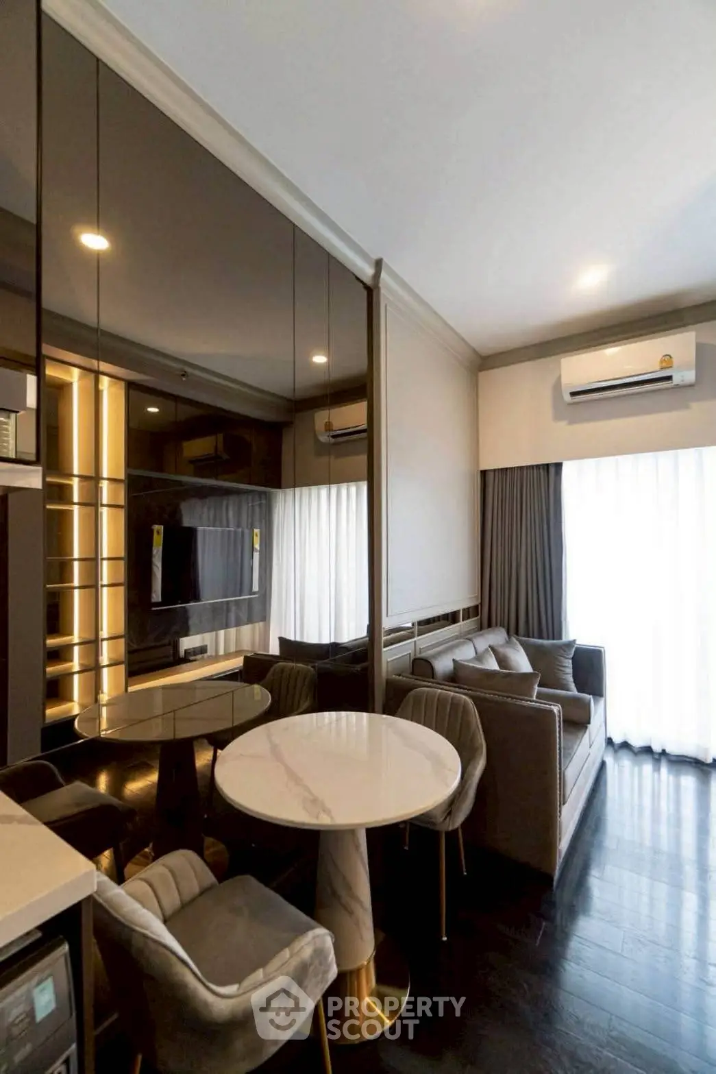 Luxurious modern living room with elegant furniture and large windows for natural light.
