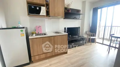 Modern compact kitchen with balcony view in stylish apartment