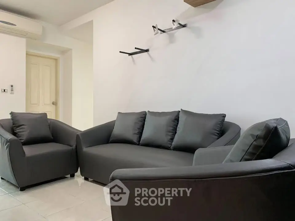 Modern living room with sleek gray sofas and minimalist decor