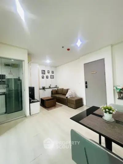 Modern living room with cozy sofa and dining area in stylish apartment.