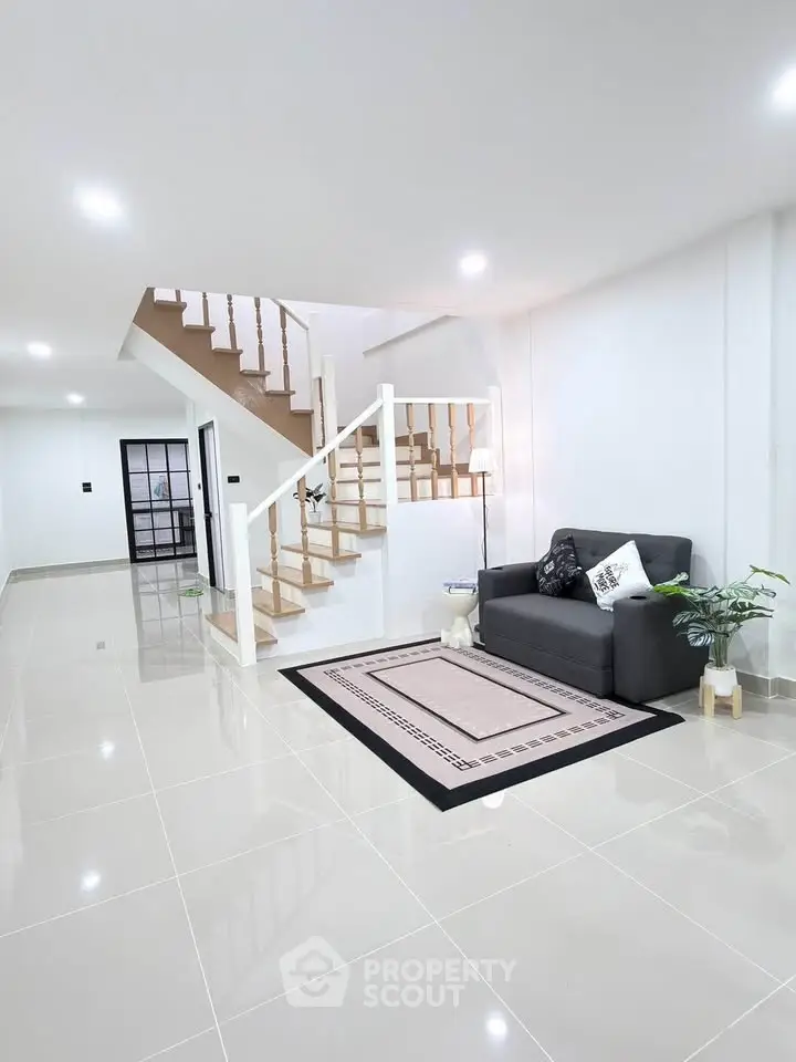 Spacious modern living room with sleek staircase and stylish decor