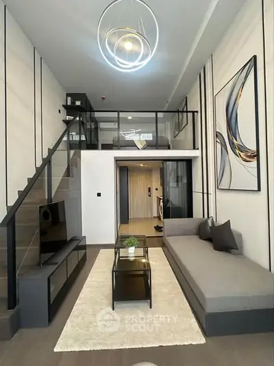 Modern loft-style living room with mezzanine, sleek decor, and stylish lighting.