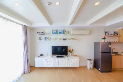 Spacious living room with modern decor and open kitchen layout