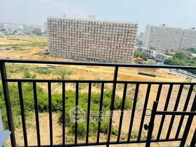 Spacious balcony with stunning cityscape and greenery views, perfect for relaxation and enjoying urban living.