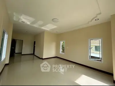 Spacious empty room with large windows and tiled floor, ideal for customization.