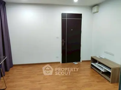 Minimalist living room with wooden flooring and modern door