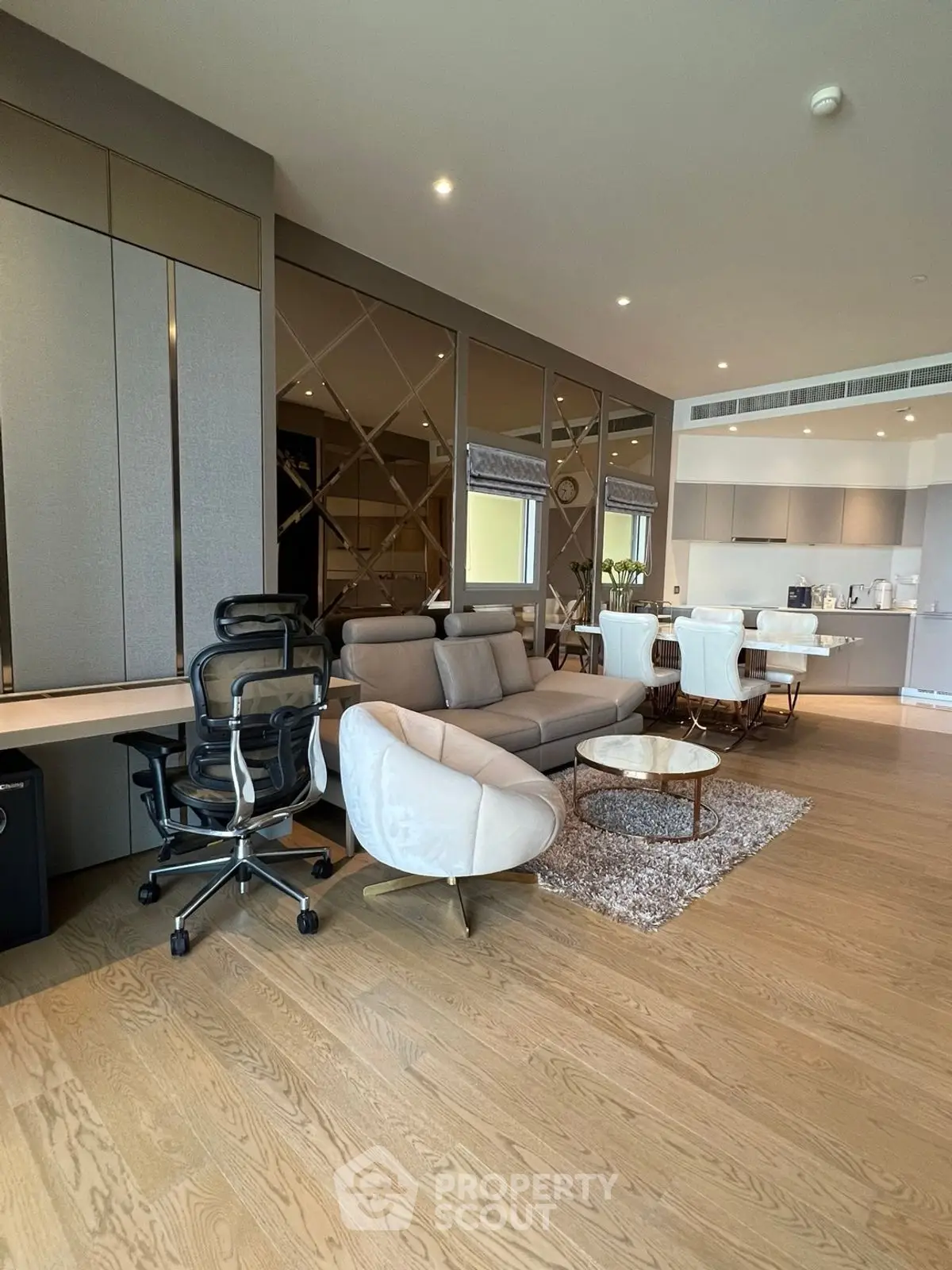 Luxurious modern living room with elegant furniture and open kitchen layout