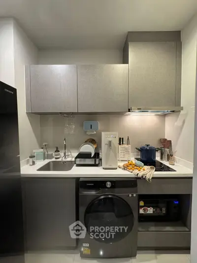 Modern kitchen with sleek appliances and compact design