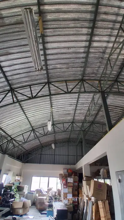 Spacious industrial warehouse with high ceilings and ample storage space.