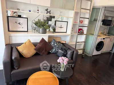 Stylish living room with modern decor and integrated kitchen appliances, perfect for urban living.