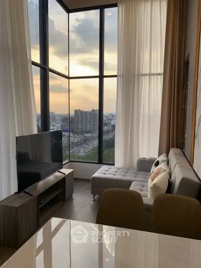 Luxurious living room with floor-to-ceiling windows offering stunning city views at sunset.