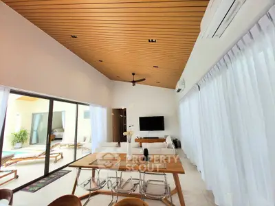 Luxurious open-plan living room with elegant wooden ceiling and modern decor