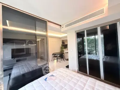 Modern bedroom with glass partitions and sleek interior design