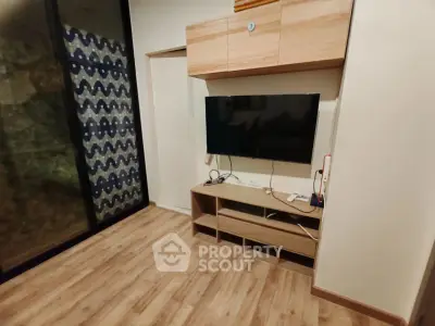 Modern living room with wooden flooring and built-in TV unit