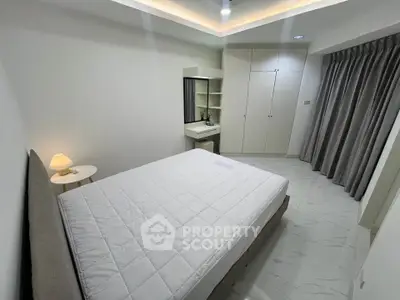 Modern minimalist bedroom with sleek design and ample storage space