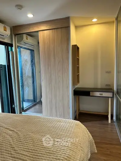 Cozy bedroom with wooden flooring and sliding closet doors