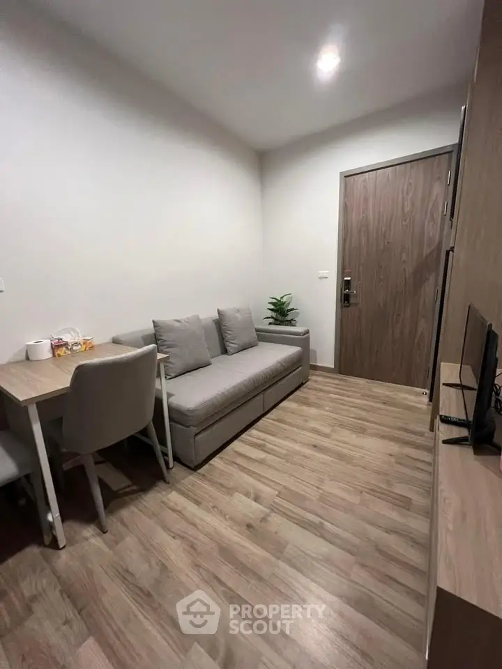 Cozy modern living room with wooden flooring and minimalist furniture