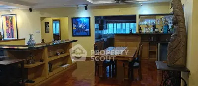 Spacious living room with wooden flooring and open kitchen layout