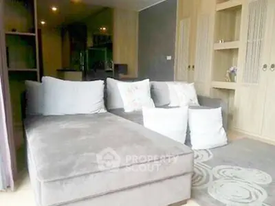 Spacious living room with modern sofa and elegant decor in a cozy apartment.