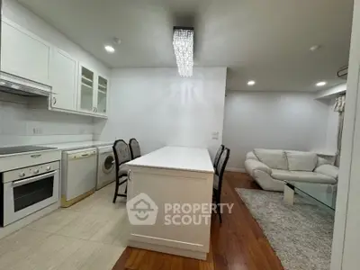 Modern open-layout kitchen with sleek appliances and cozy living area, perfect for entertaining.