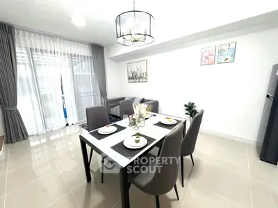 Modern dining area with elegant decor and natural light in a stylish apartment.
