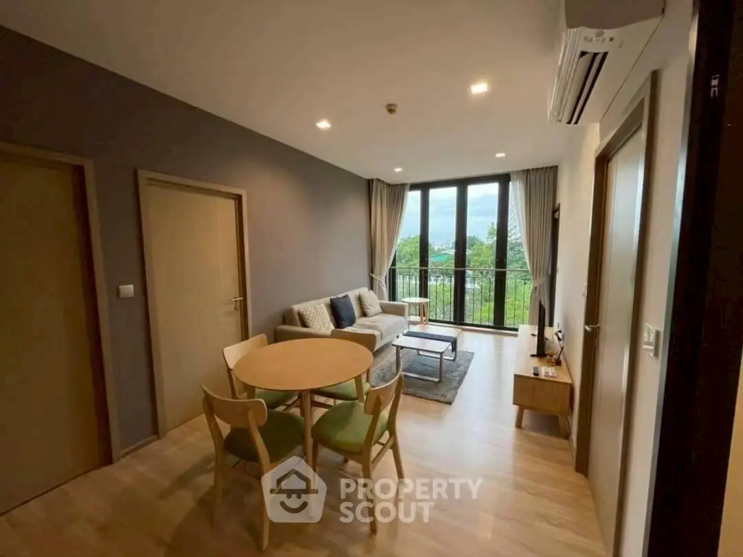 Modern living room with balcony view and stylish furniture