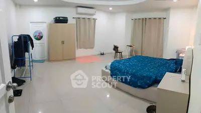 Spacious bedroom with modern decor and ample natural light