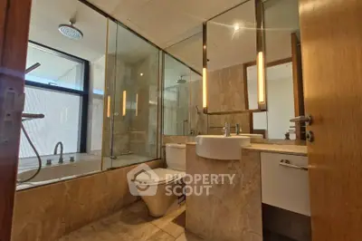 Luxurious bathroom with modern fixtures and elegant marble design, featuring a spacious bathtub and sleek vanity.