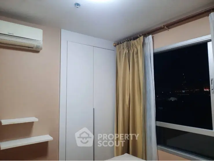 Cozy bedroom with air conditioning and night city view from window