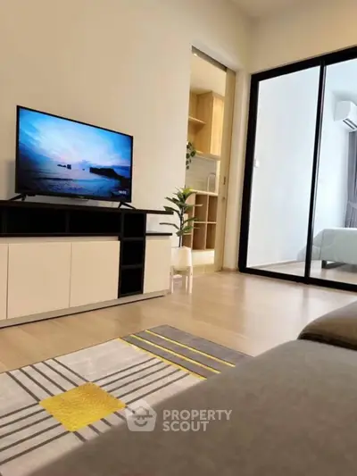 Modern living room with sleek TV setup and cozy decor