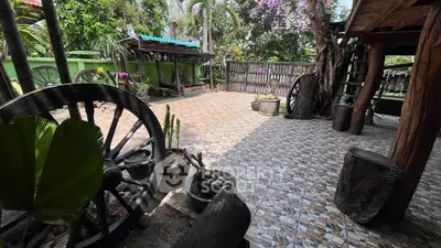 Charming rustic garden with unique wooden decor and lush greenery, perfect for outdoor relaxation and gatherings.