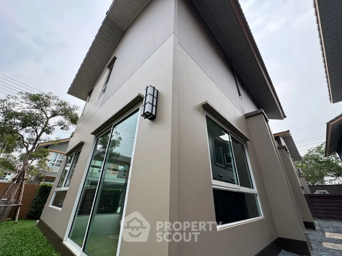 Modern two-story house exterior with large windows and sleek design