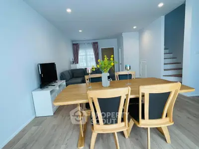 Spacious modern living room with wooden dining set and cozy seating area