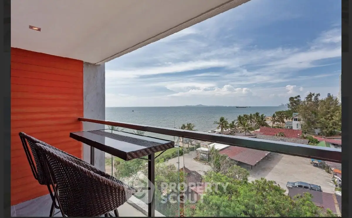 Stunning ocean view from modern balcony with stylish seating