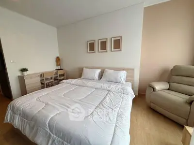 Cozy bedroom with modern decor and comfortable seating
