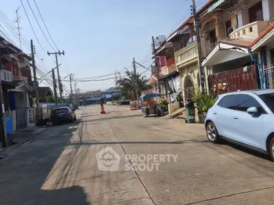 Charming residential street with colorful houses and parked cars, perfect for family living.